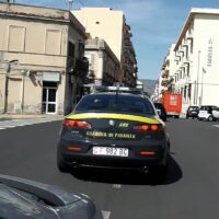 Auto dei carabinieri in una strada urbana italiana, sfondo edifici, evidenza targa, giorno soleggiato
